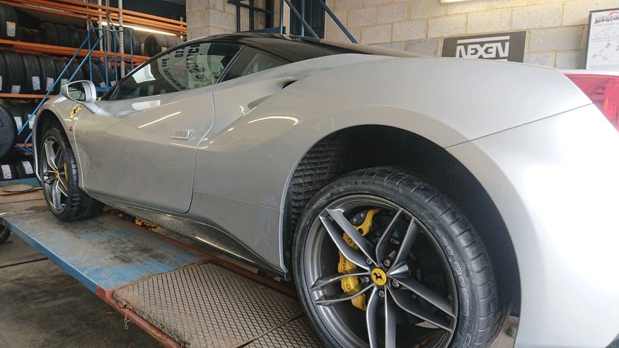 Silver Ferrari on the alignment ramp in the Vale Tyre Services workshop