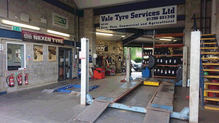 Inside the workshop: ramps, tyre racks and the Vale Tyre Services Ltd sign